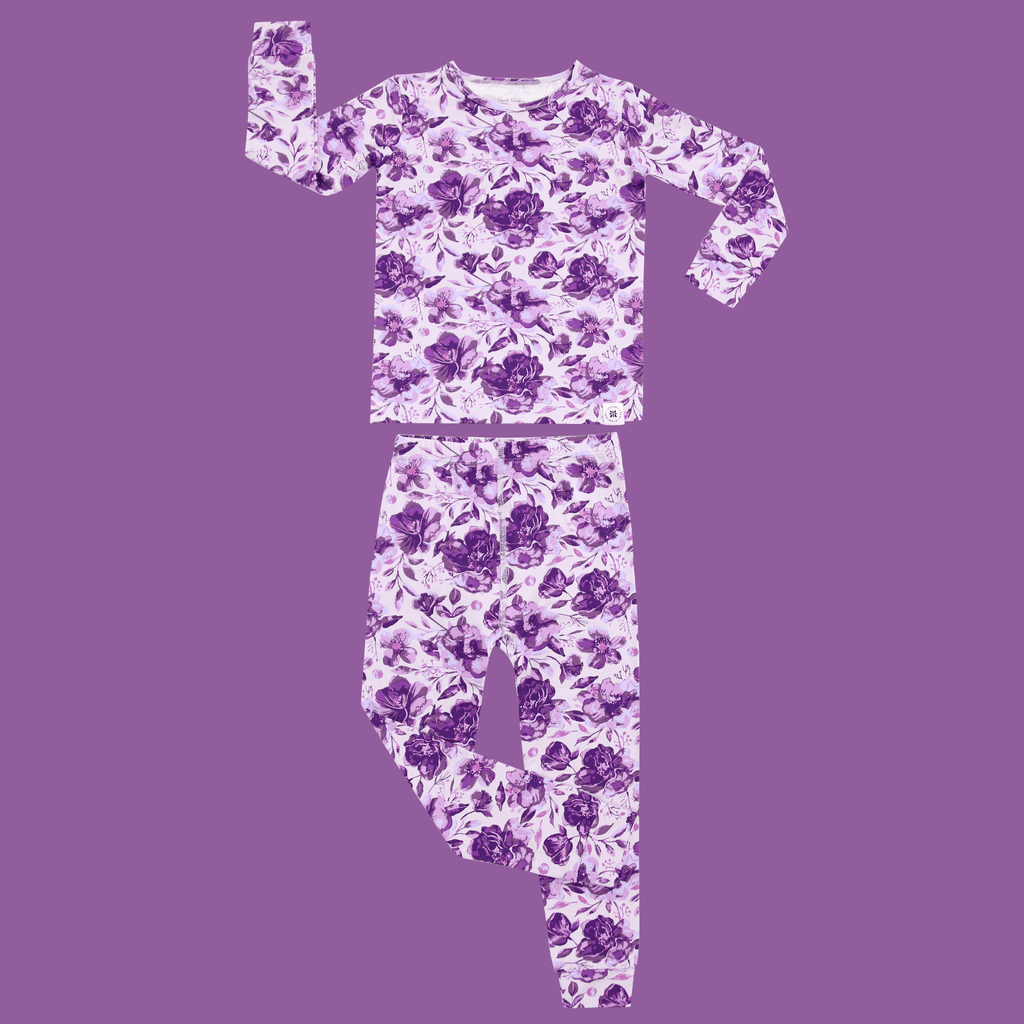 Kids purple floral pajama set, long-sleeve top and pants shown flat