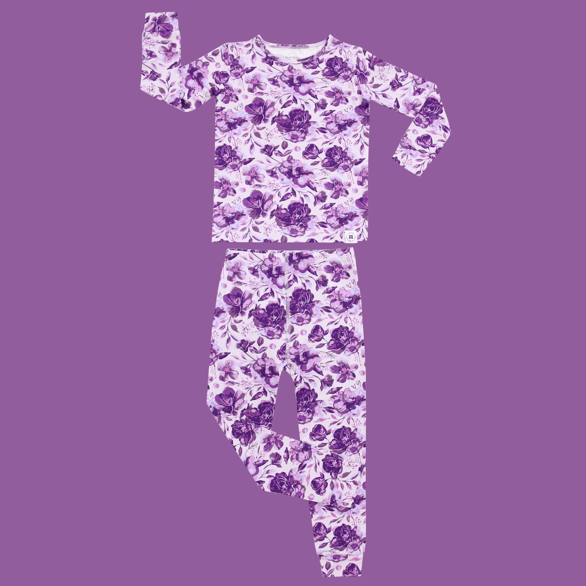 Kids purple floral pajama set, long-sleeve top and pants shown flat