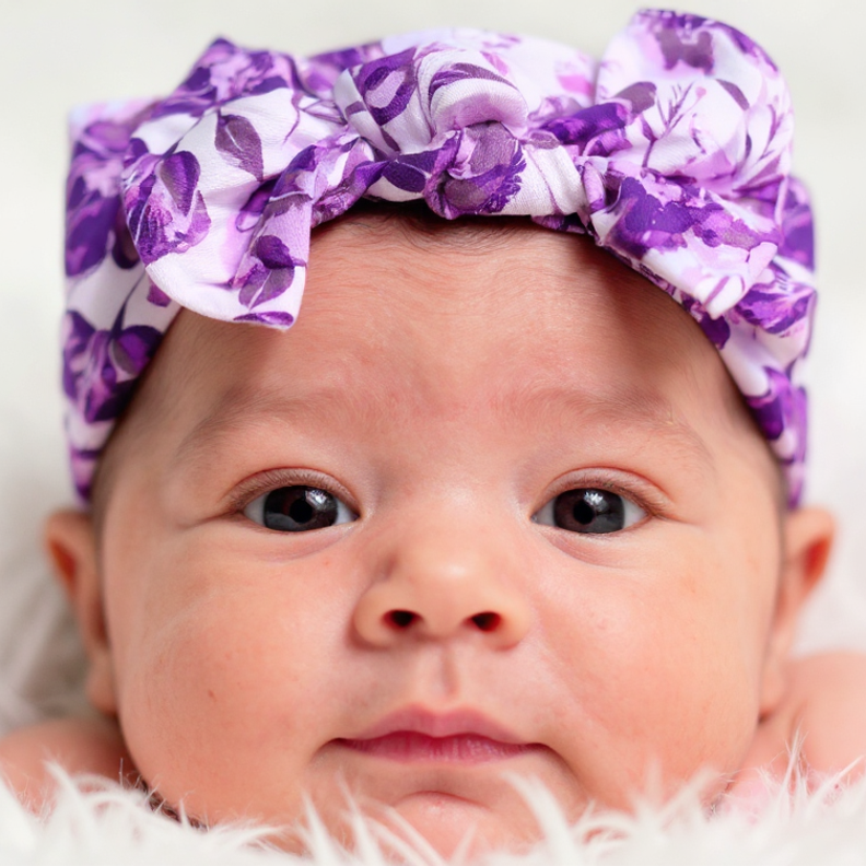 Knotted bow baby headband with purple floral fabric, soft ruffles around top