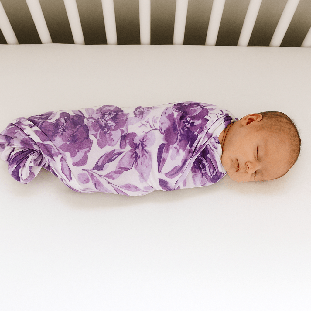 Purple floral baby swaddle wrap with gathered fold and smooth fabric