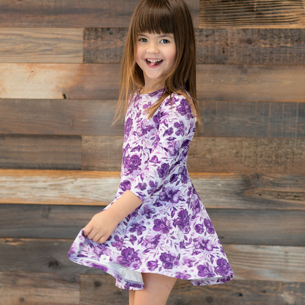 Girls purple floral long-sleeve dress with gathered skirt, side view