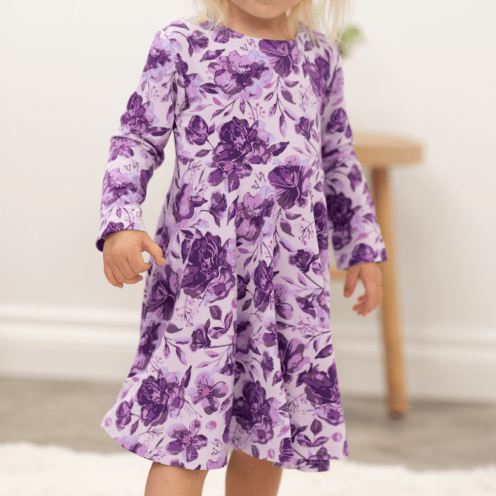 Girls purple floral long-sleeve dress with gathered skirt, front view, hands at sides