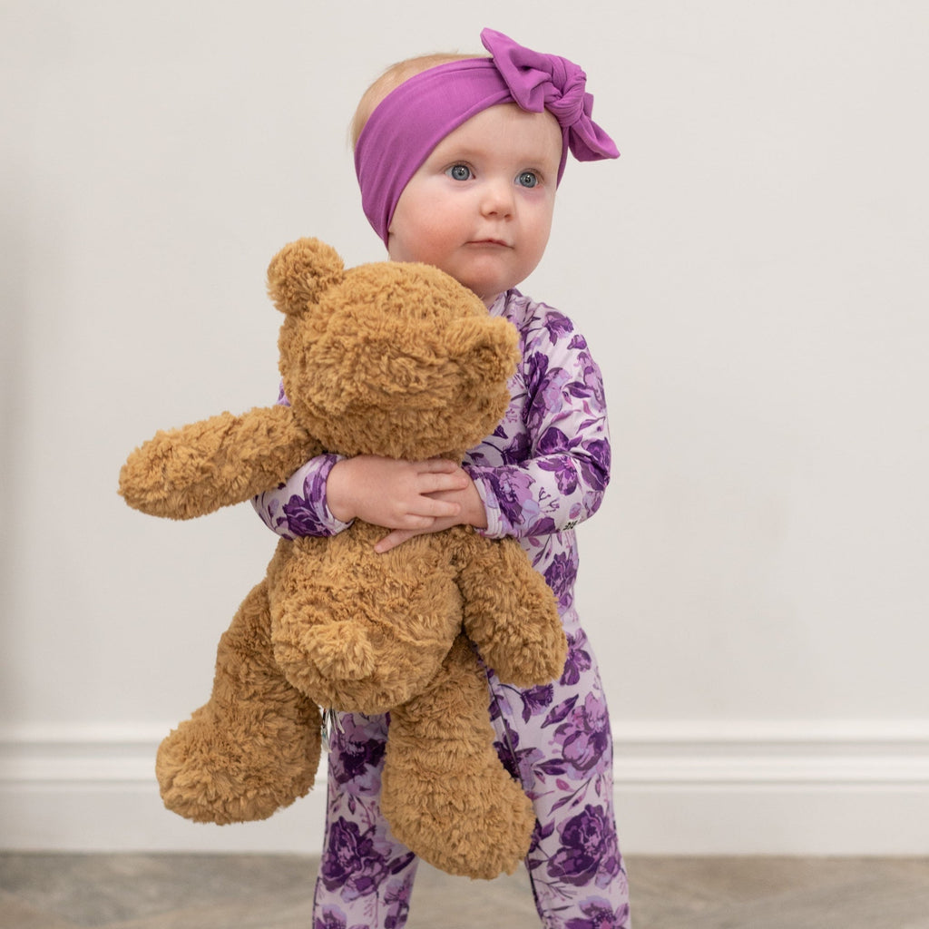 Purple floral zipper footie pajama with long sleeves and footed legs, zip front.