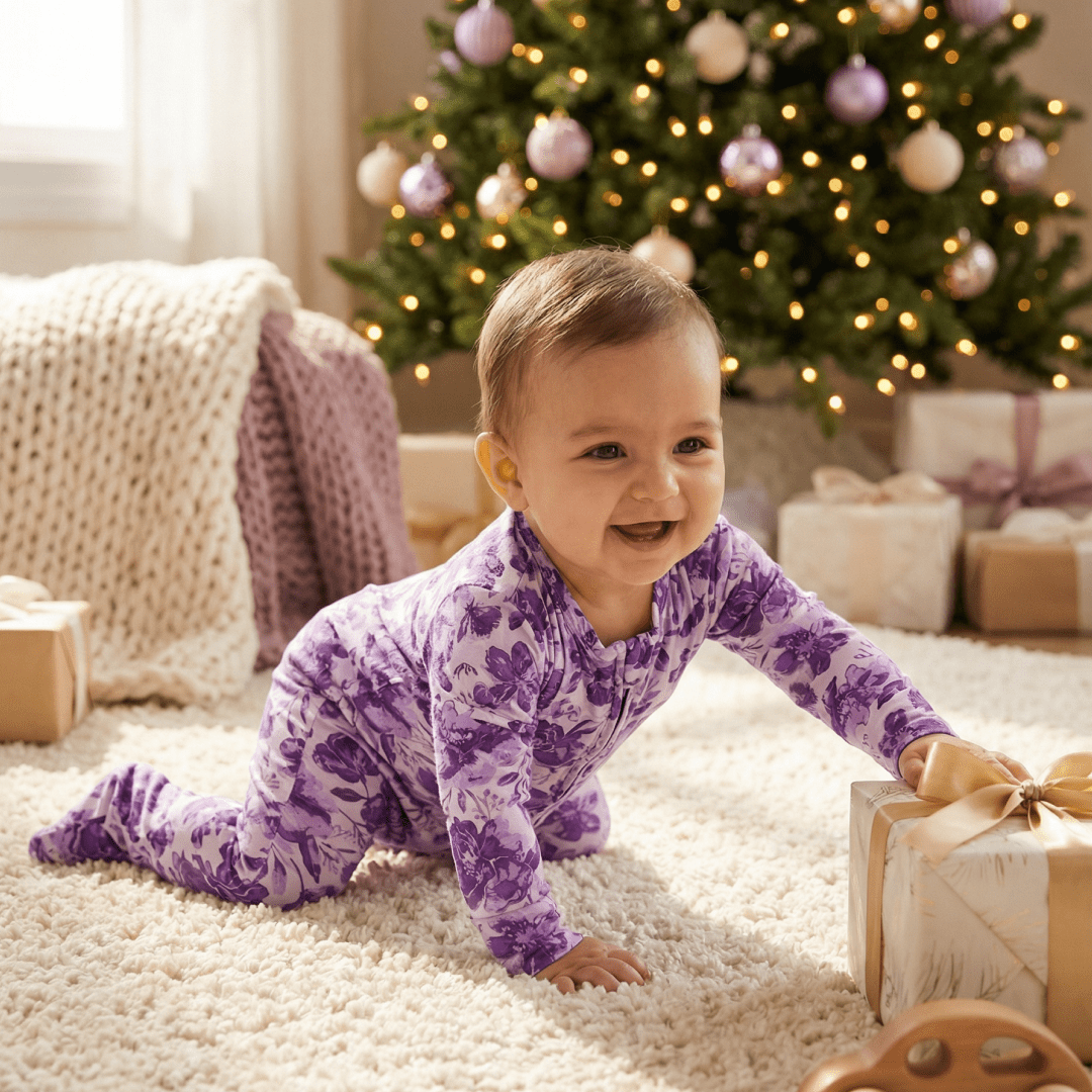 Purple floral zipper footie pajama for baby, long sleeves and zip front.