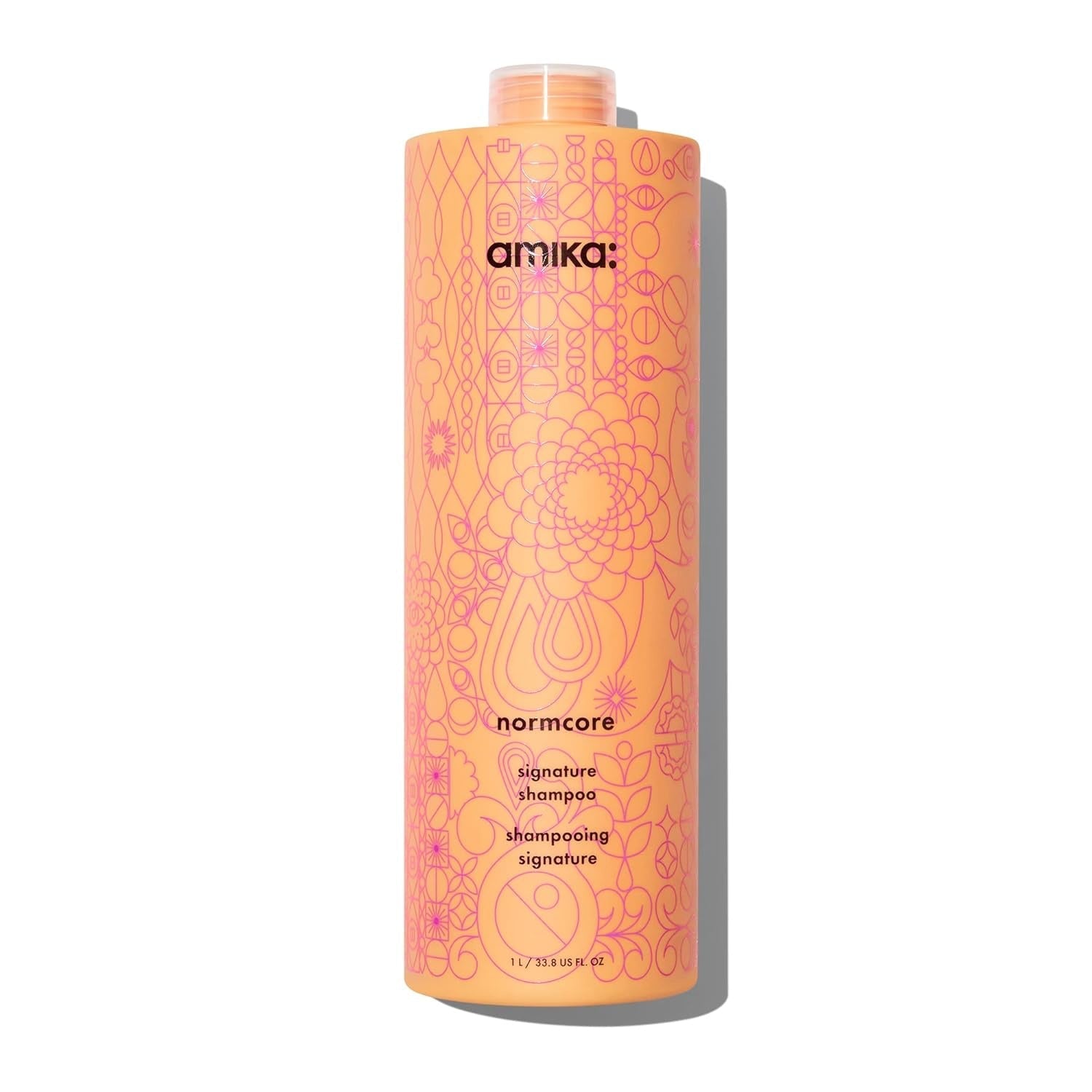 Orange shampoo bottle with label and pump cap from Amika Normcore