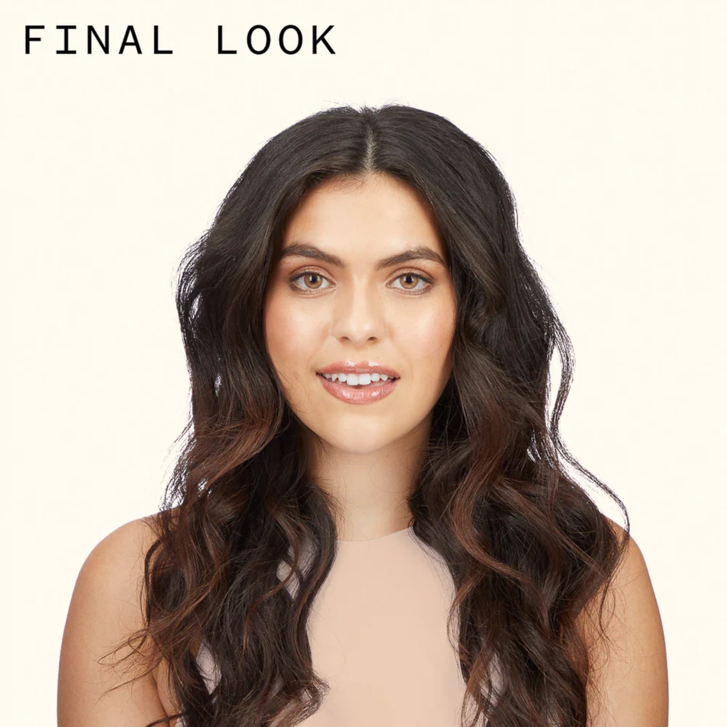 Woman with wavy dark hair and bare shoulders, centered portrait