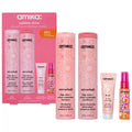 Amika hair care set with pink bottles, including shampoo, conditioner, and hair mist spray