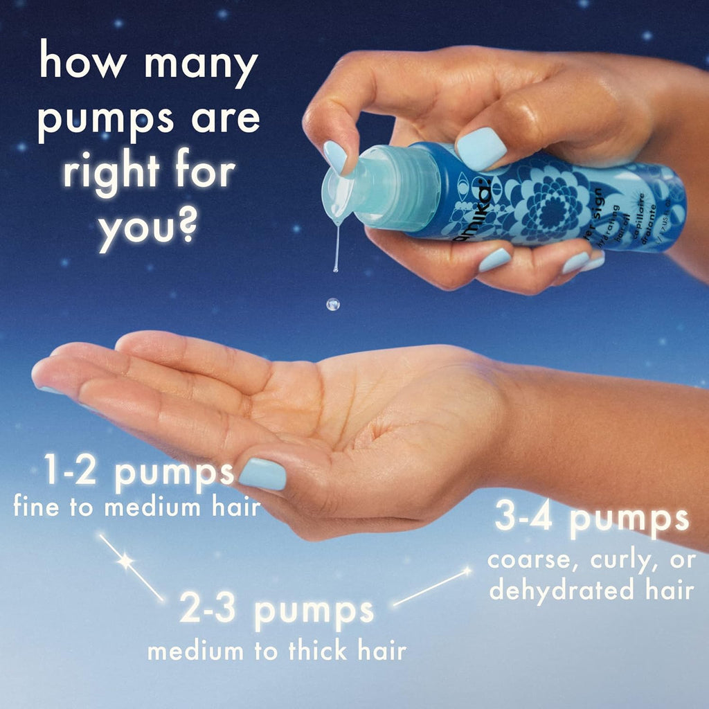 Hands holding blue Amika hair oil bottle, dispensing a drop from the nozzle