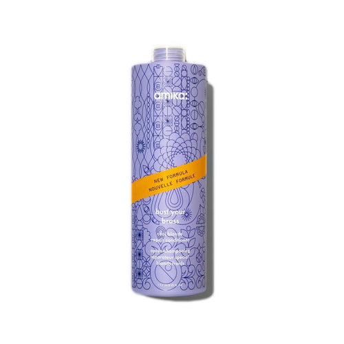Amika purple conditioner bottle with yellow label and flip-top cap