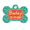 Arrow dog name tag bone shape, green forest pattern with orange Bailey ID and number