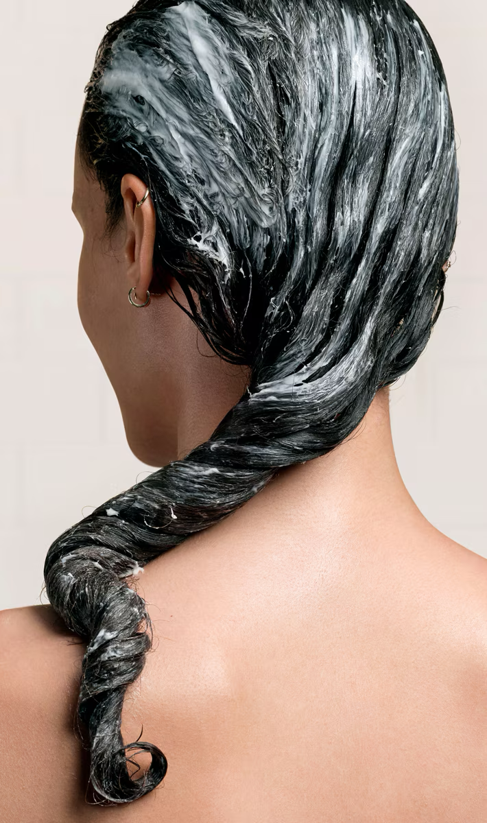 Dark hair with creamy product, shown from back and sides