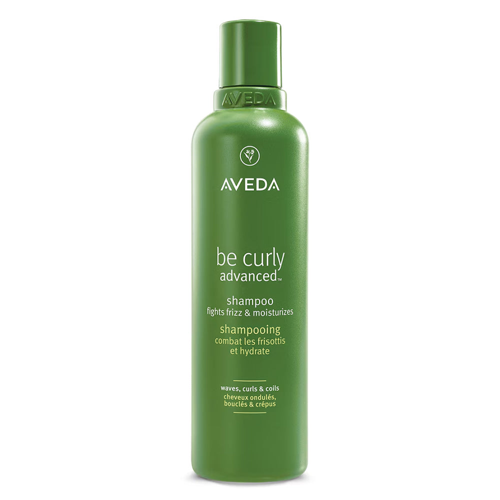 Green Aveda shampoo bottle, be curly advanced label on front