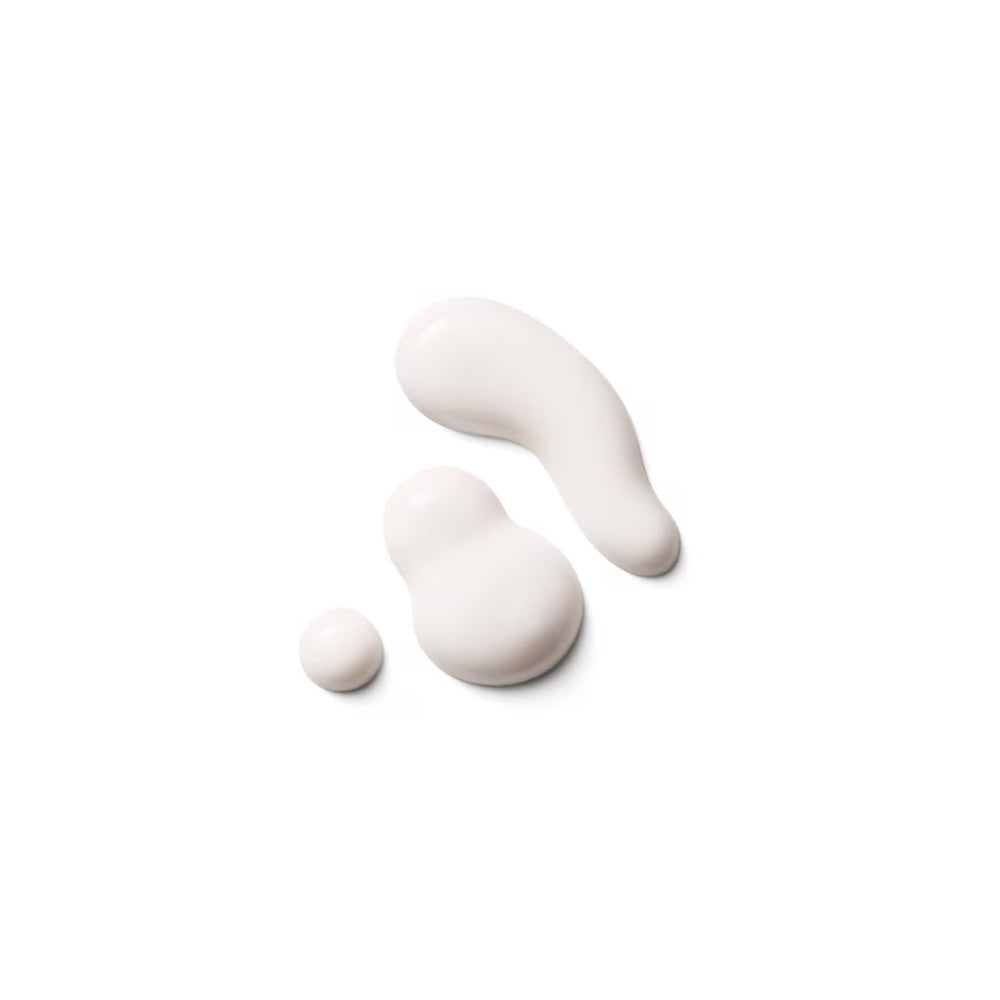 Creamy serum swatches in light, dollop-shaped texture on a plain surface