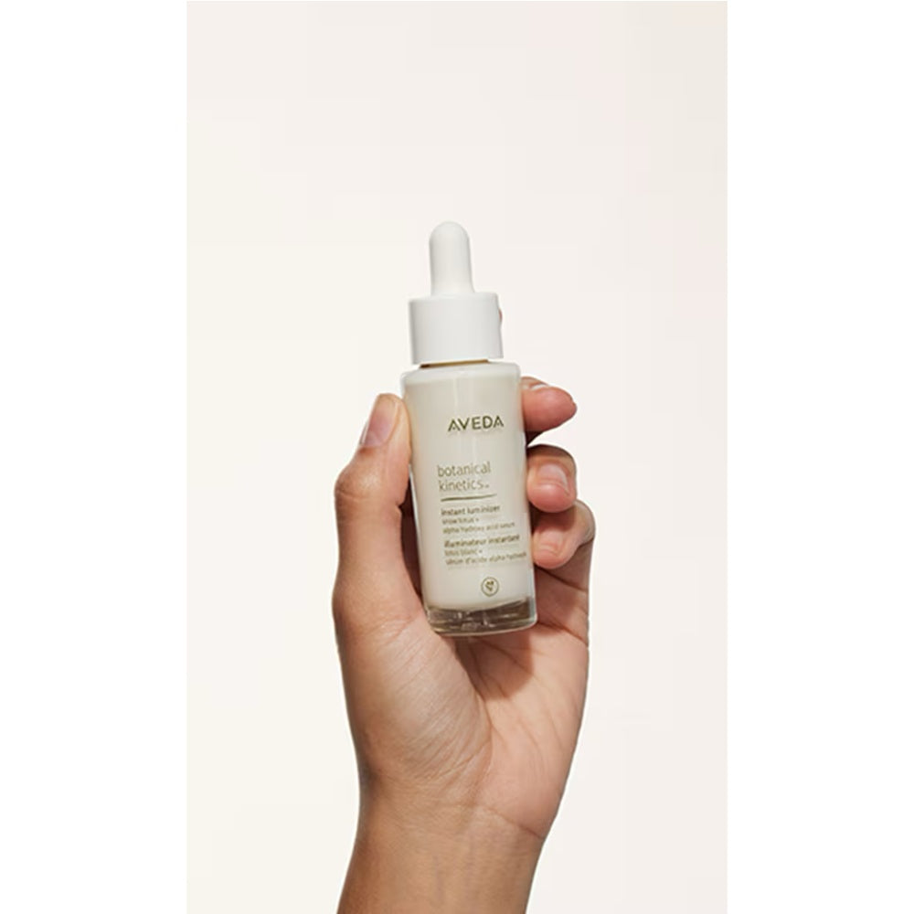 Aveda Botanical Kinetics Instant Luminizer bottle in hand with dropper