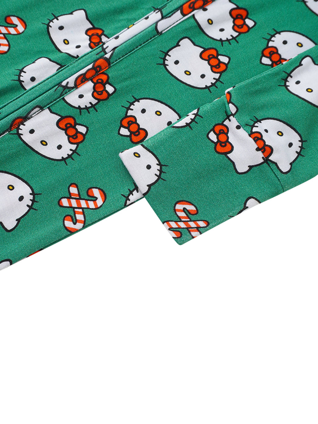 Green baby romper fabric close-up with Hello Kitty faces and candy-cane icons