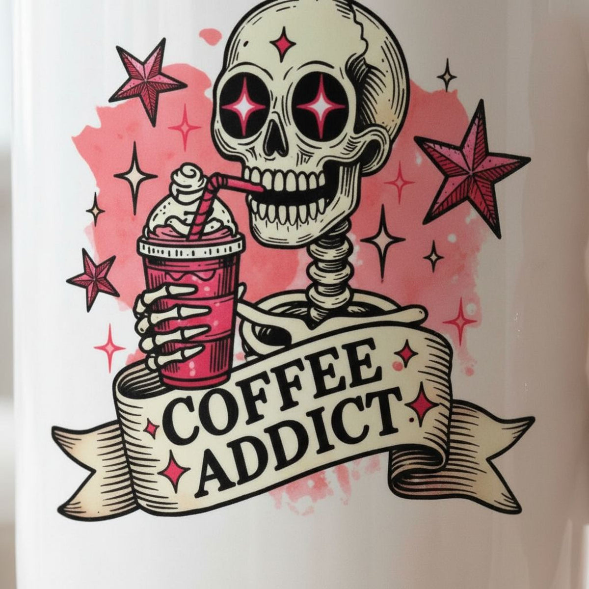 White ceramic coffee mug close-up showing pink skull and 'Coffee Addict' text and stars