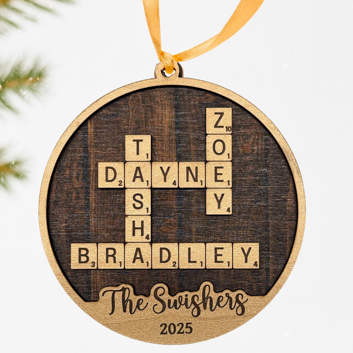 Round wooden Christmas ornament with engraved word puzzle and "The Swishers" 2025, ribbon