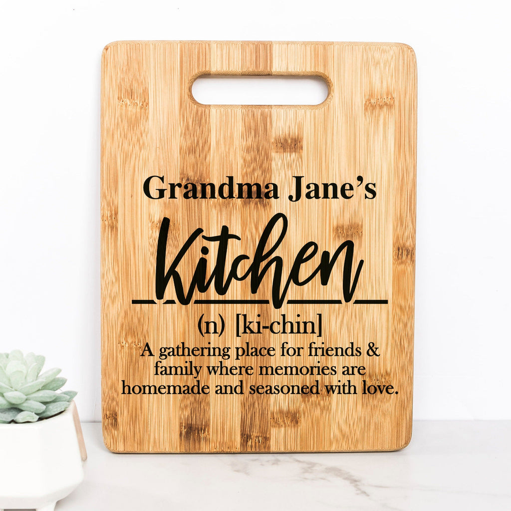 Bamboo cutting board with handle cutout, engraved 'Grandma Jane's Kitchen' text