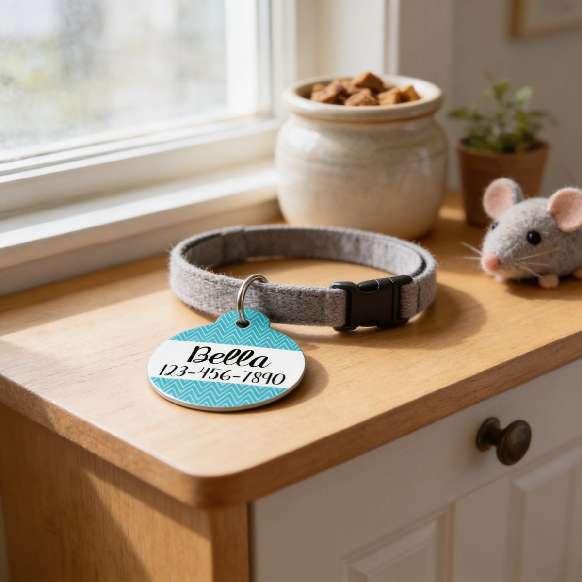 Round turquoise chevron ID tag on gray cat collar with metal ring