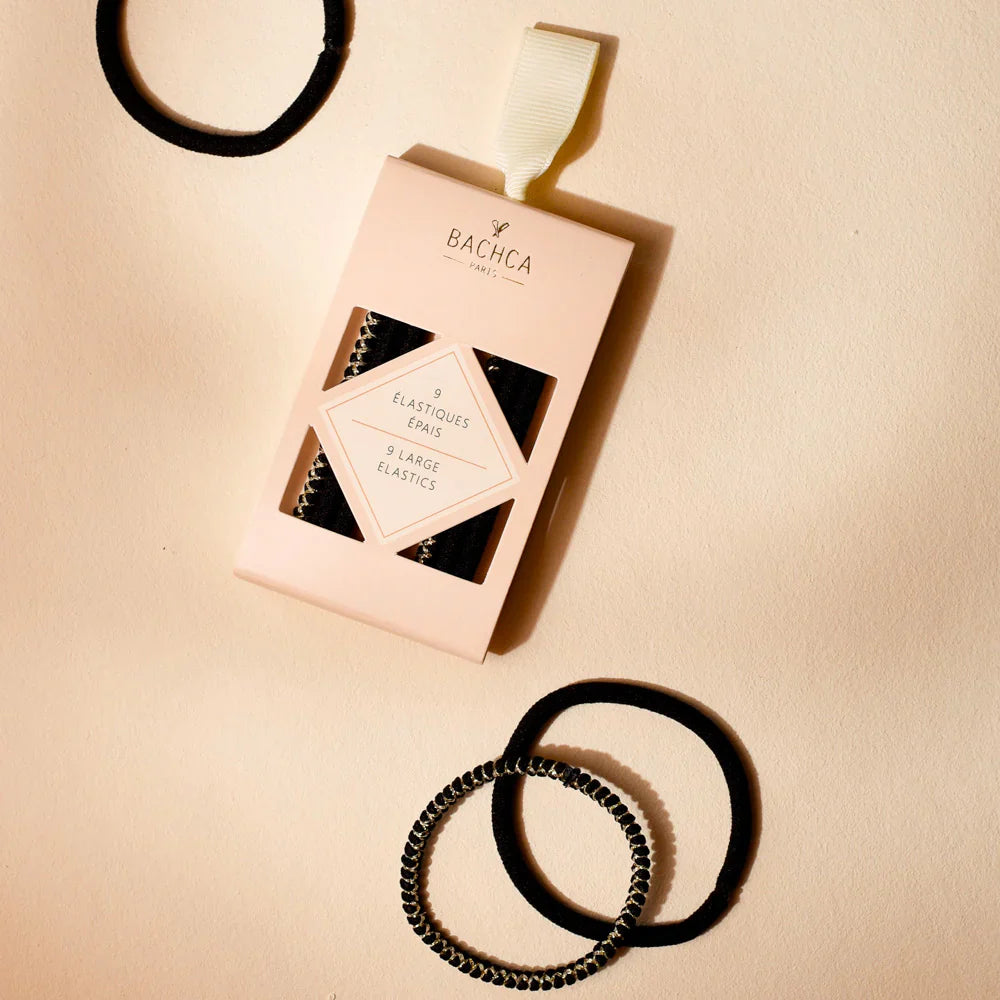 Thick black hair elastics, two coiled elastic bands with bead-like texture.