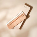 Bachca wooden comb with light wood handle and evenly spaced teeth