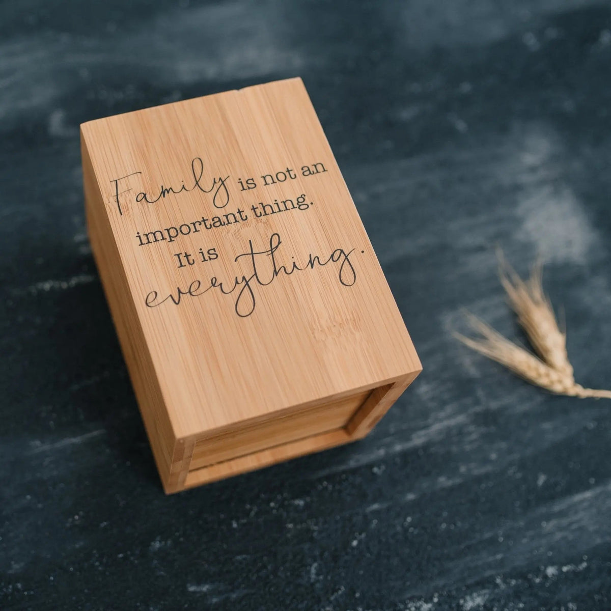 Bamboo utensil holder with 'Family is not an important thing' quote