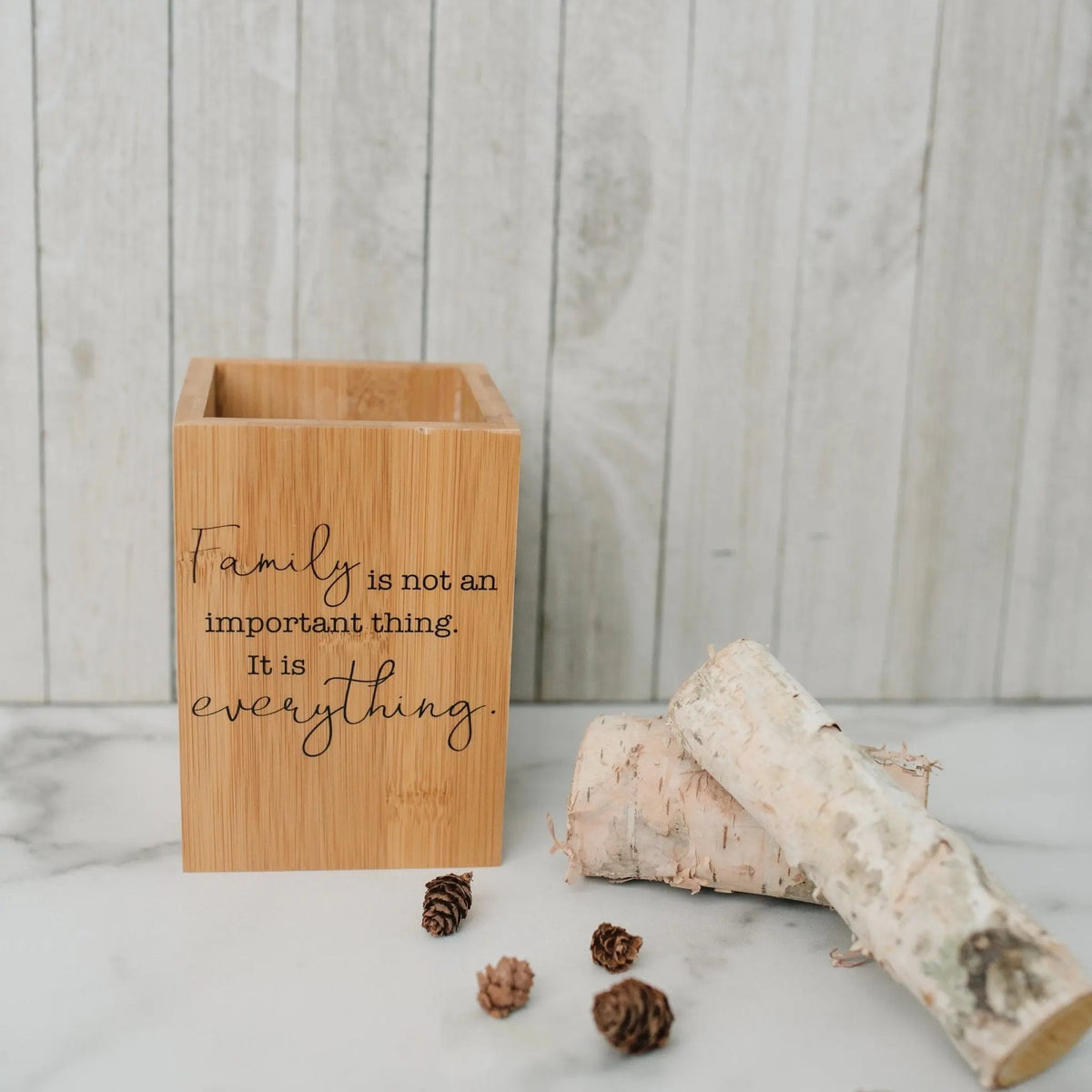 Bamboo utensil holder with 'Family is not an important thing' quote front
