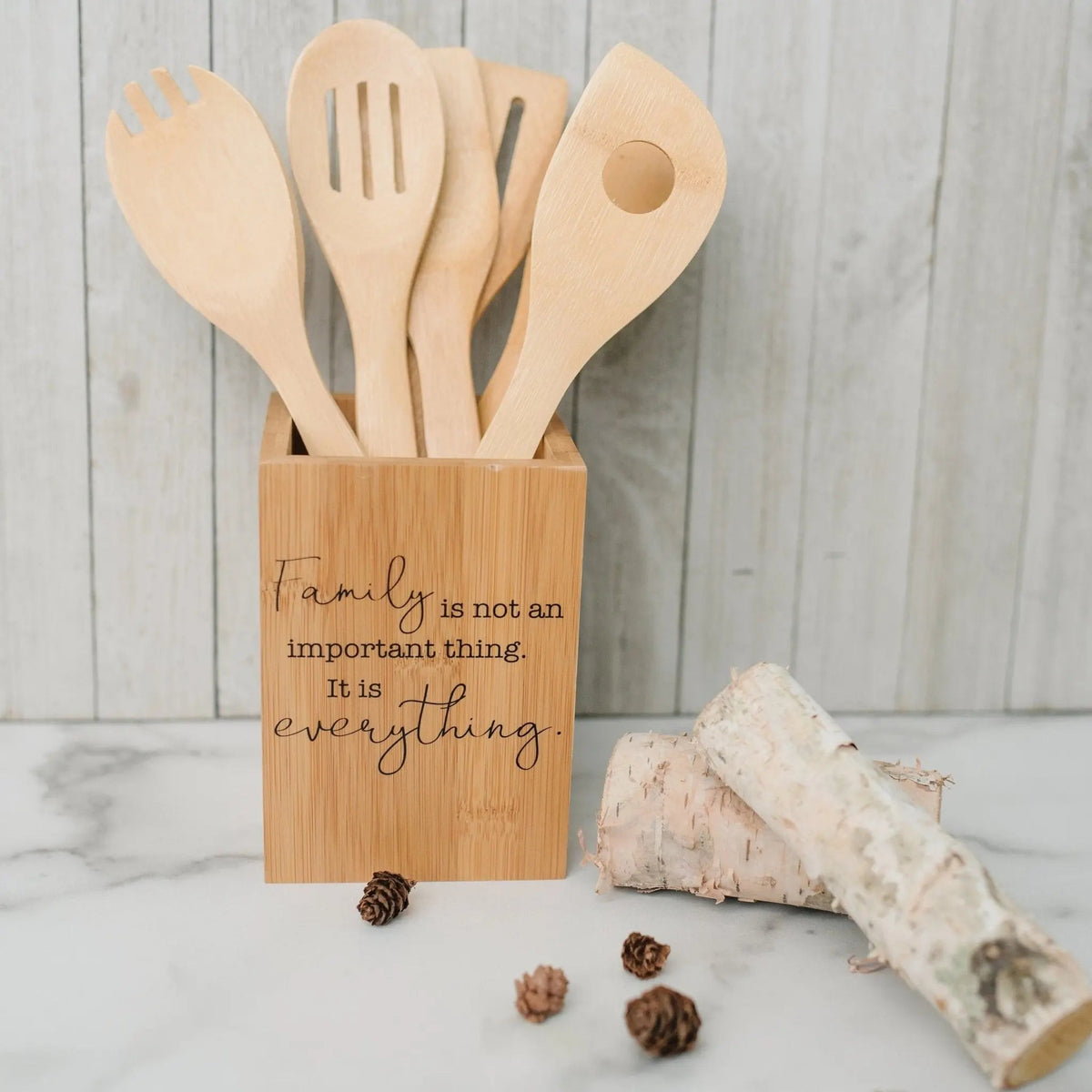 Bamboo utensil holder with carved quote and 6 wooden kitchen utensils