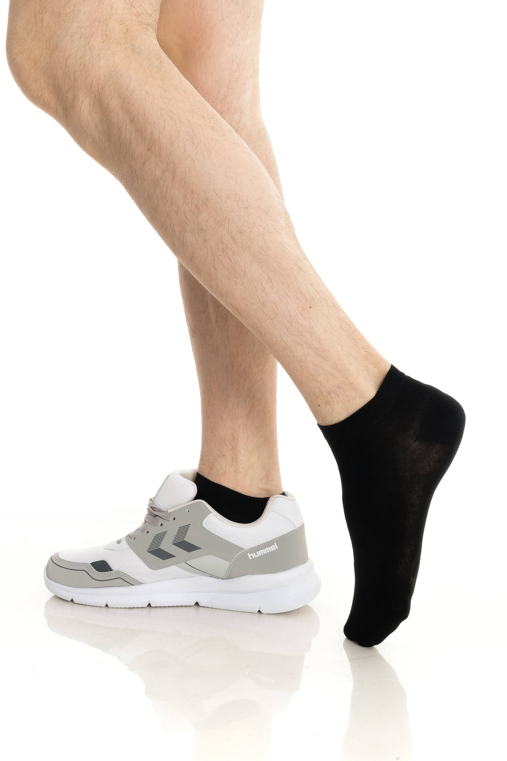 Ankle socks in black, on feet with white sneakers