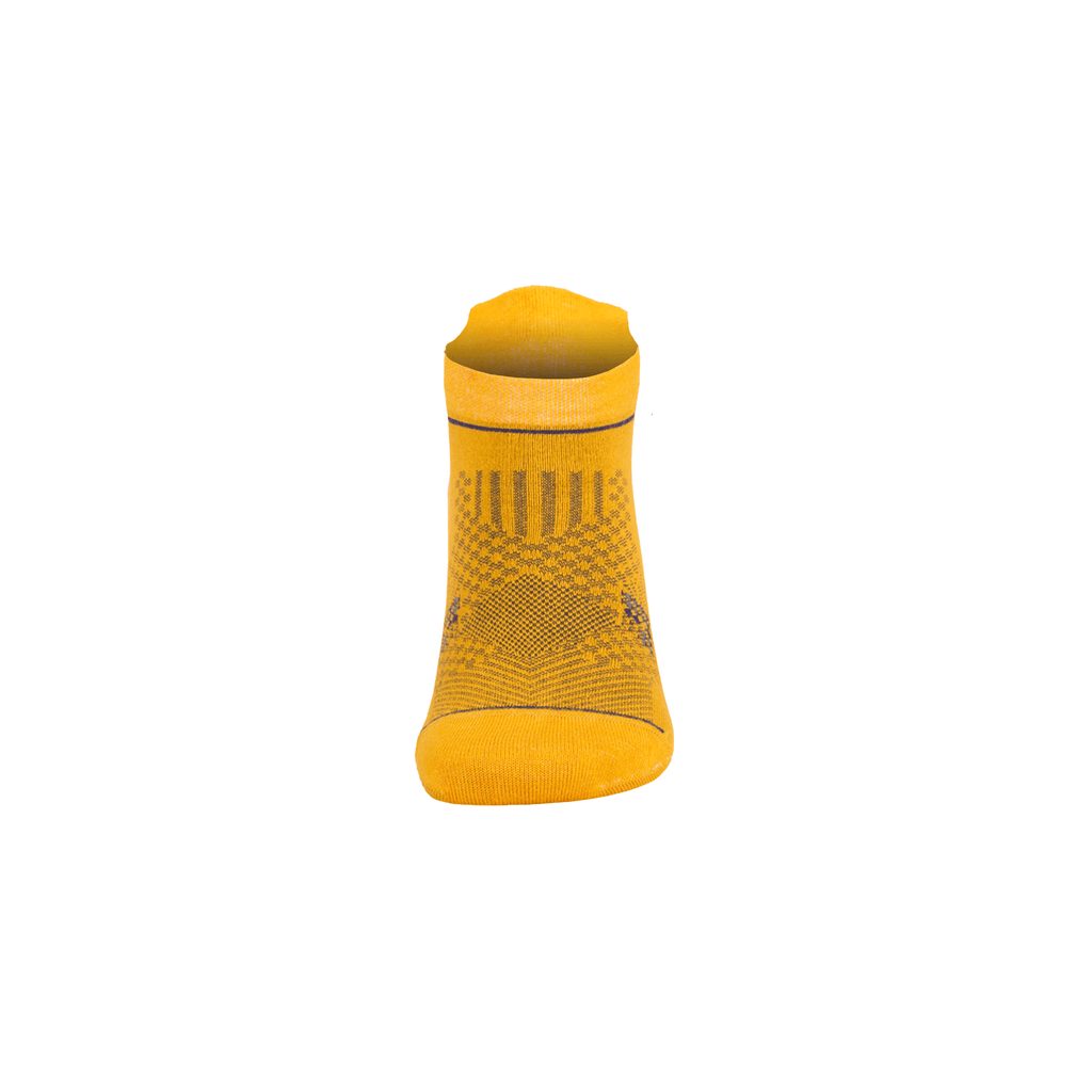 Yellow ankle socks with dark geometric knit pattern at the cuff and foot