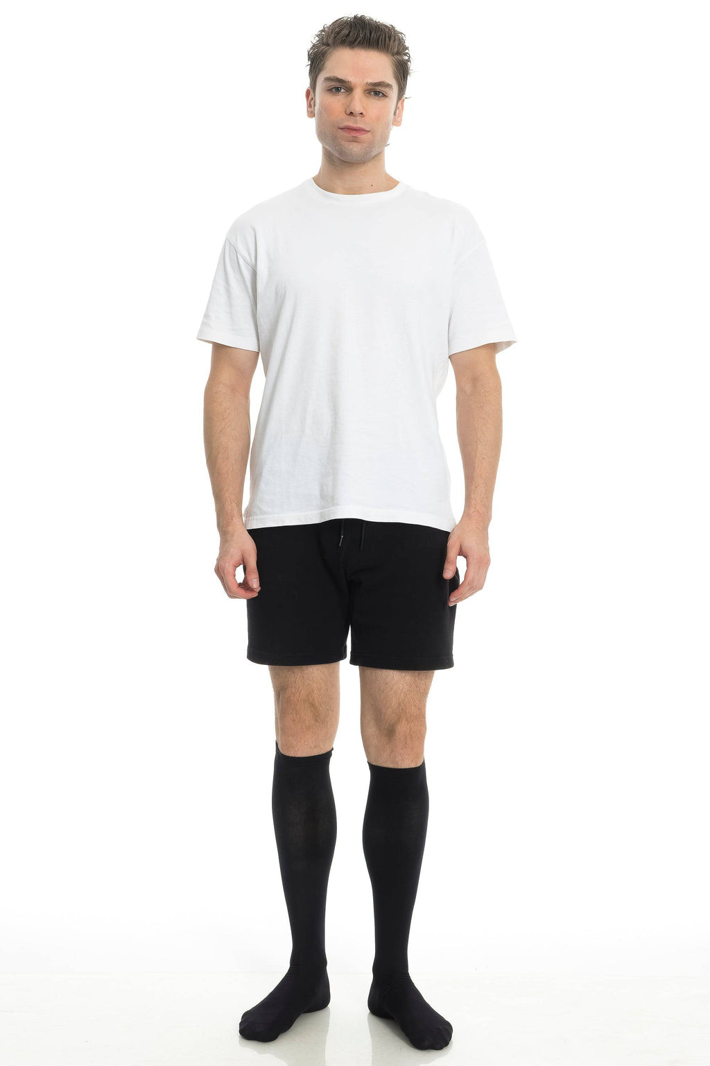 Black compression socks worn with shorts and white T-shirt
