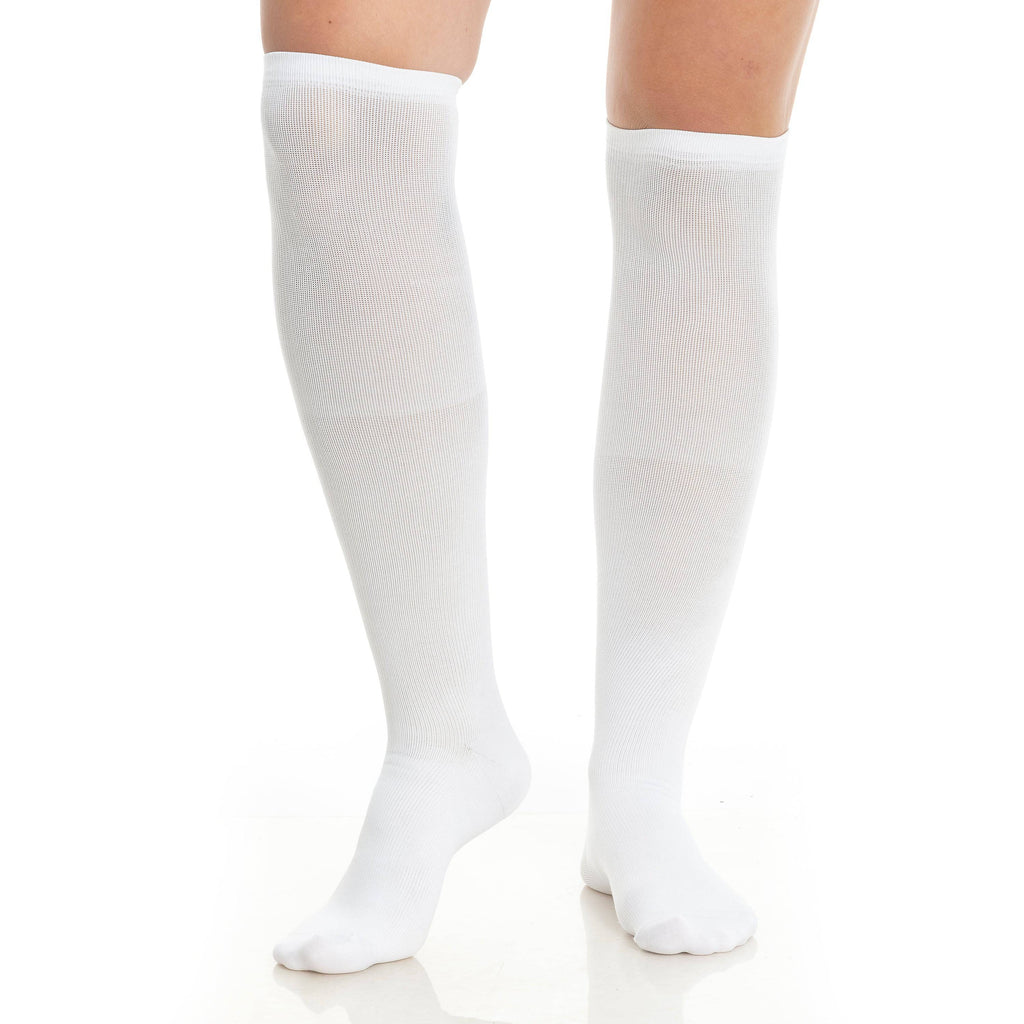 White knee-high compression socks worn on two legs