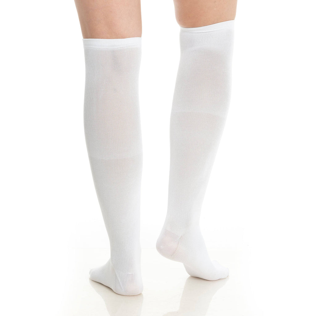 White knee-high compression socks worn on two legs