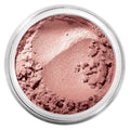 Loose powder blush in a round clear pan, rose-pink shimmer texture