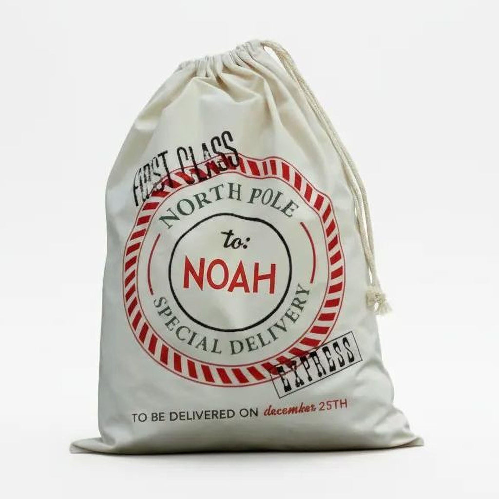 Front view of cream canvas drawstring Santa bag with North Pole seal for Noah.