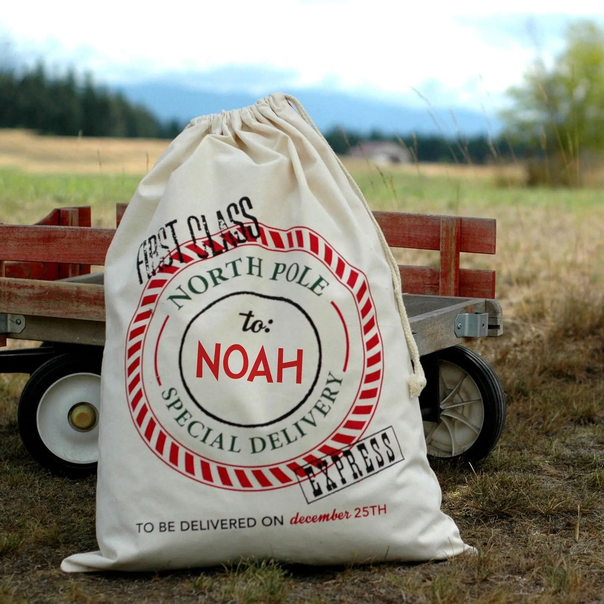 Canvas Santa sack with red 'North Pole' stamp, 'To: Noah', drawstring top.