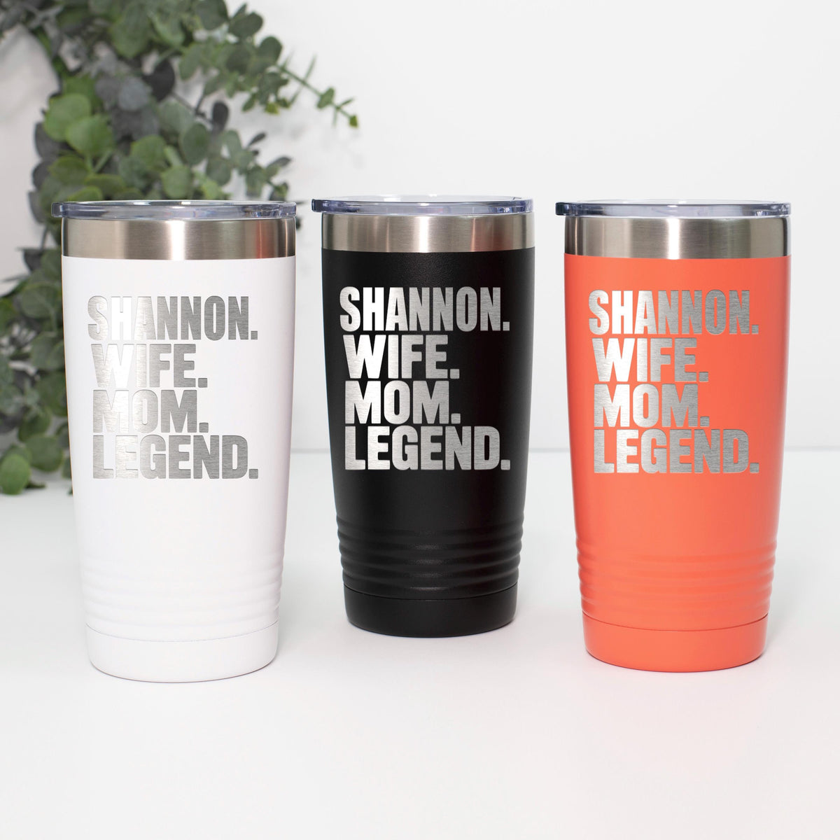 Set of personalized stainless steel tumblers in white, black, and orange with “Shannon Wife Mom Legend.”
