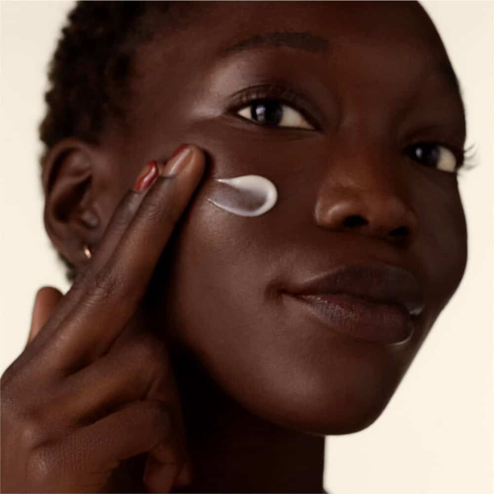 Wrinkle smoothing cream applied to cheek with a single cream swipe