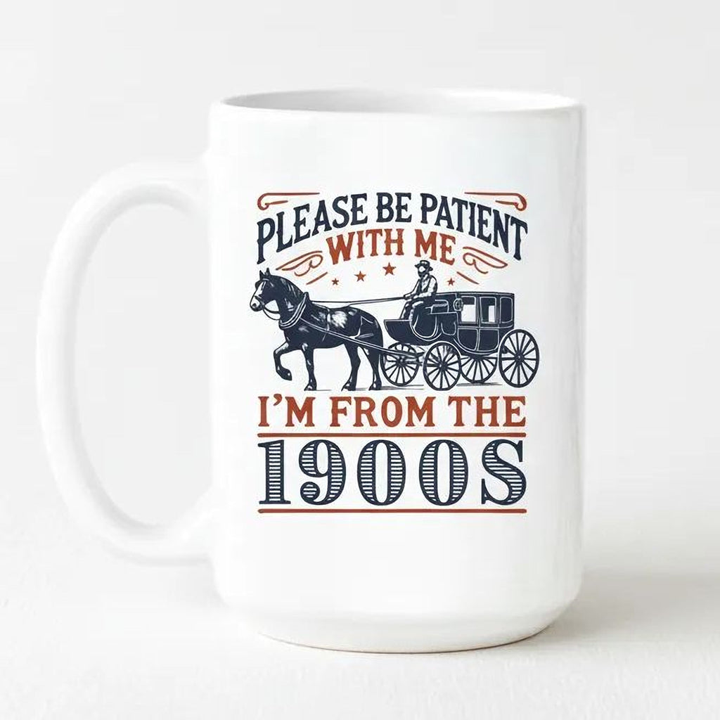 White ceramic mug with horse carriage graphic and text “Please be patient with me, I’m from the 1900s”.
