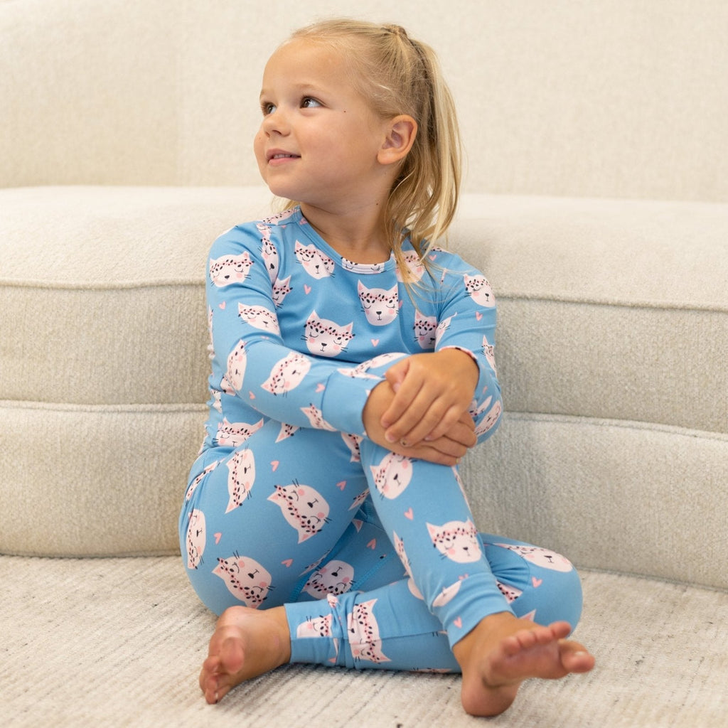 Light blue kids pajama set with long sleeves and pink cat face print