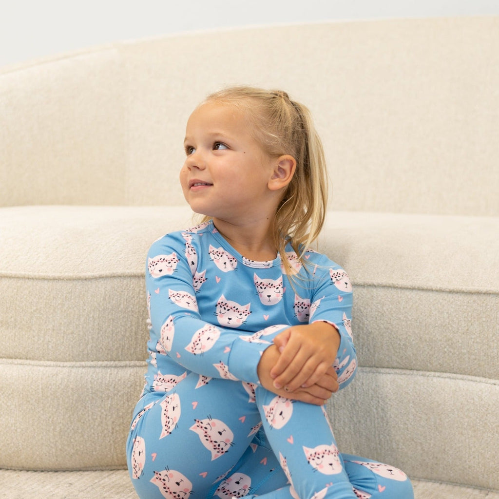 Light blue kids long-sleeve pajama with pink cat face print on front
