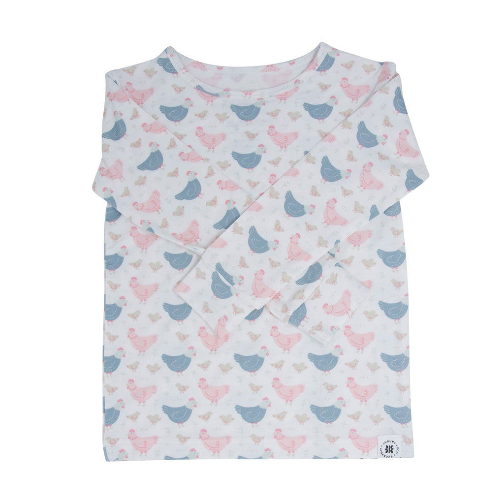 Kids bamboo pajama top with white base and blue/pink farm hen print, long sleeves