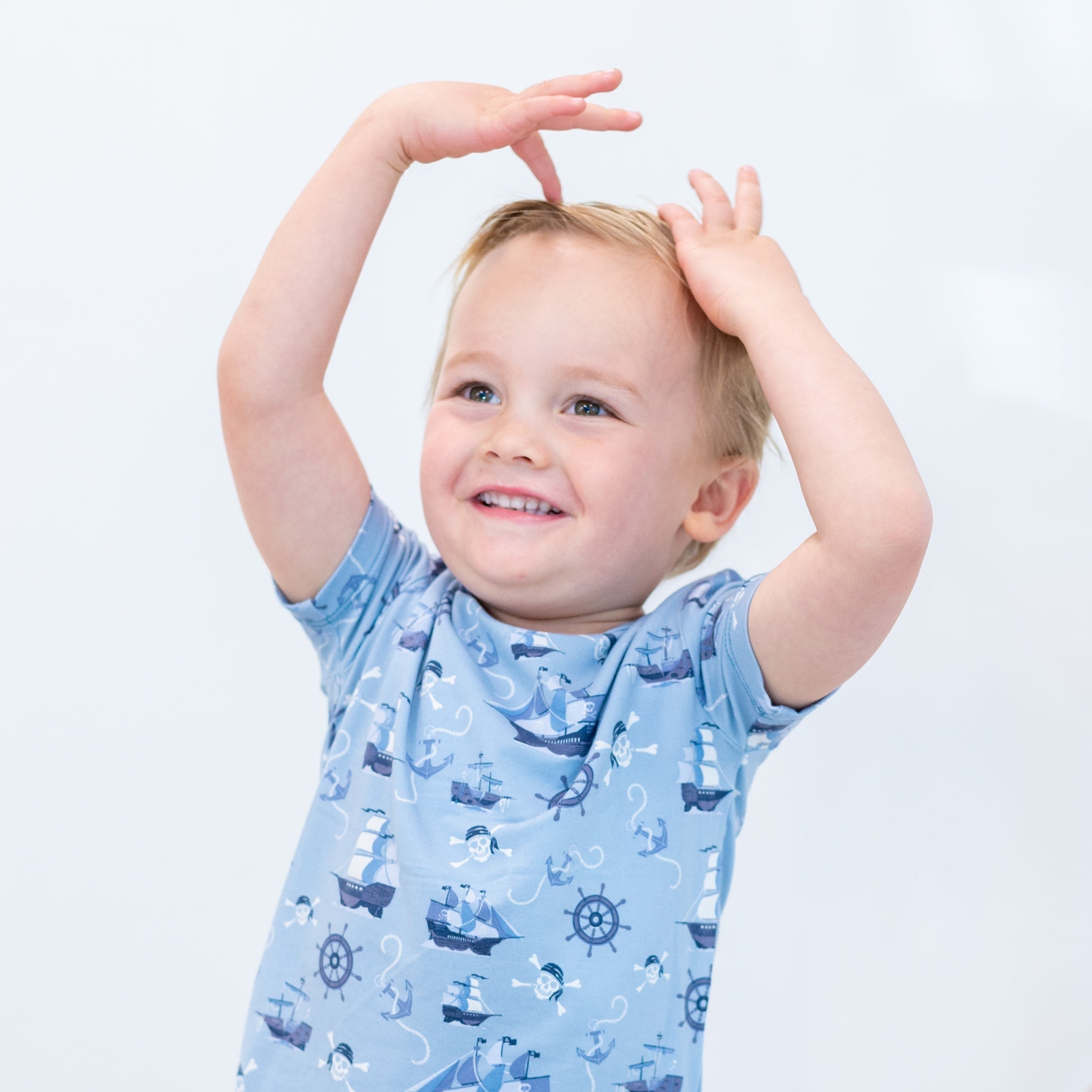 Light blue pirate-themed short-sleeve pajama top with ship, anchor, and wheel prints