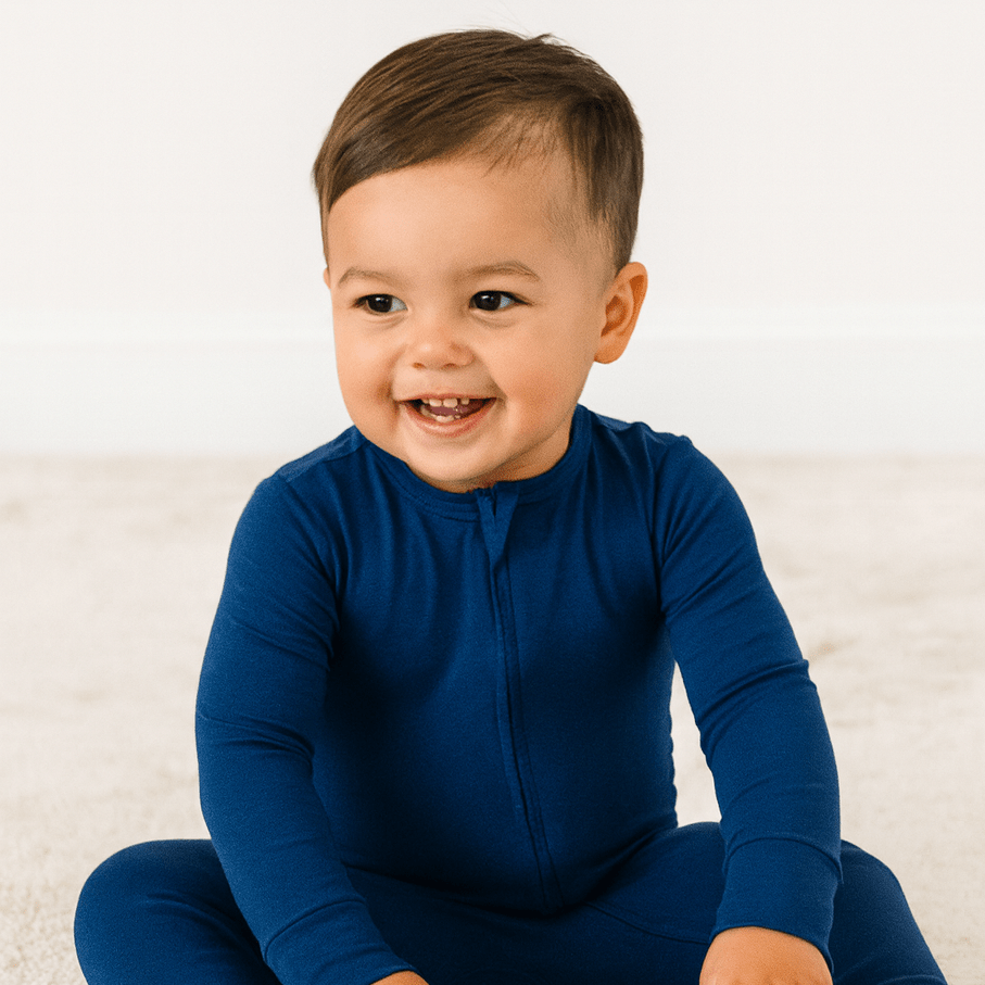 Dark blue convertible romper with full zipper front and long sleeves on a baby