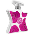 Perfume spray bottle with rounded cap, white base and magenta floral design panel.