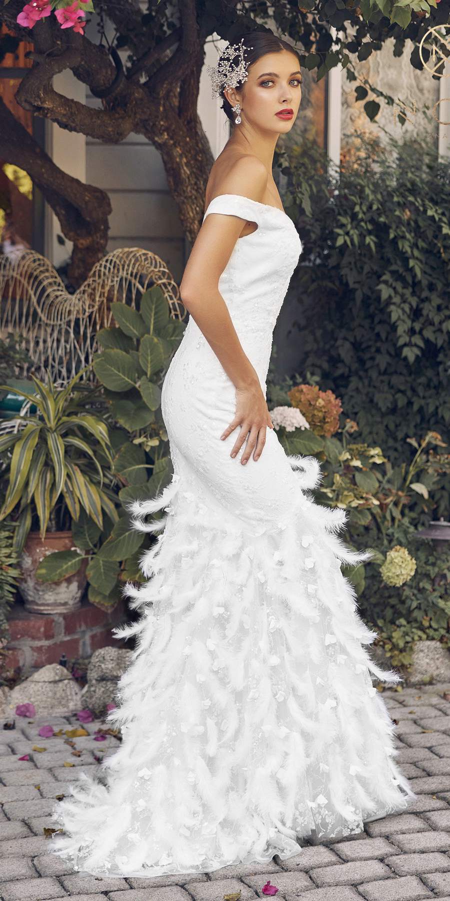 White off-shoulder mermaid gown with feathered lower skirt, side view