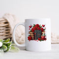 White ceramic mug with red roses, books, and Valentine cup graphic on front.