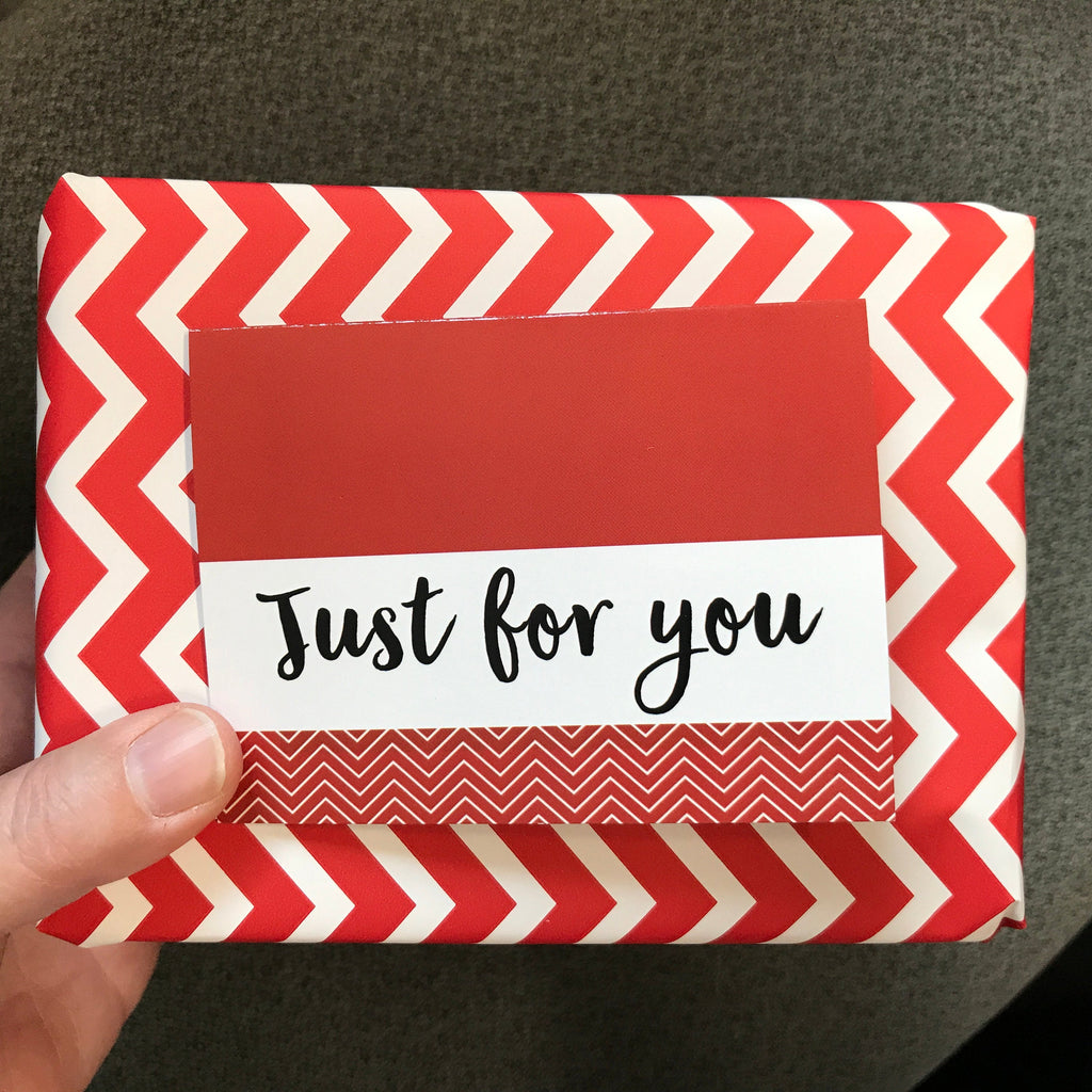 Red chevron gift card with white banner reading “Just for you”