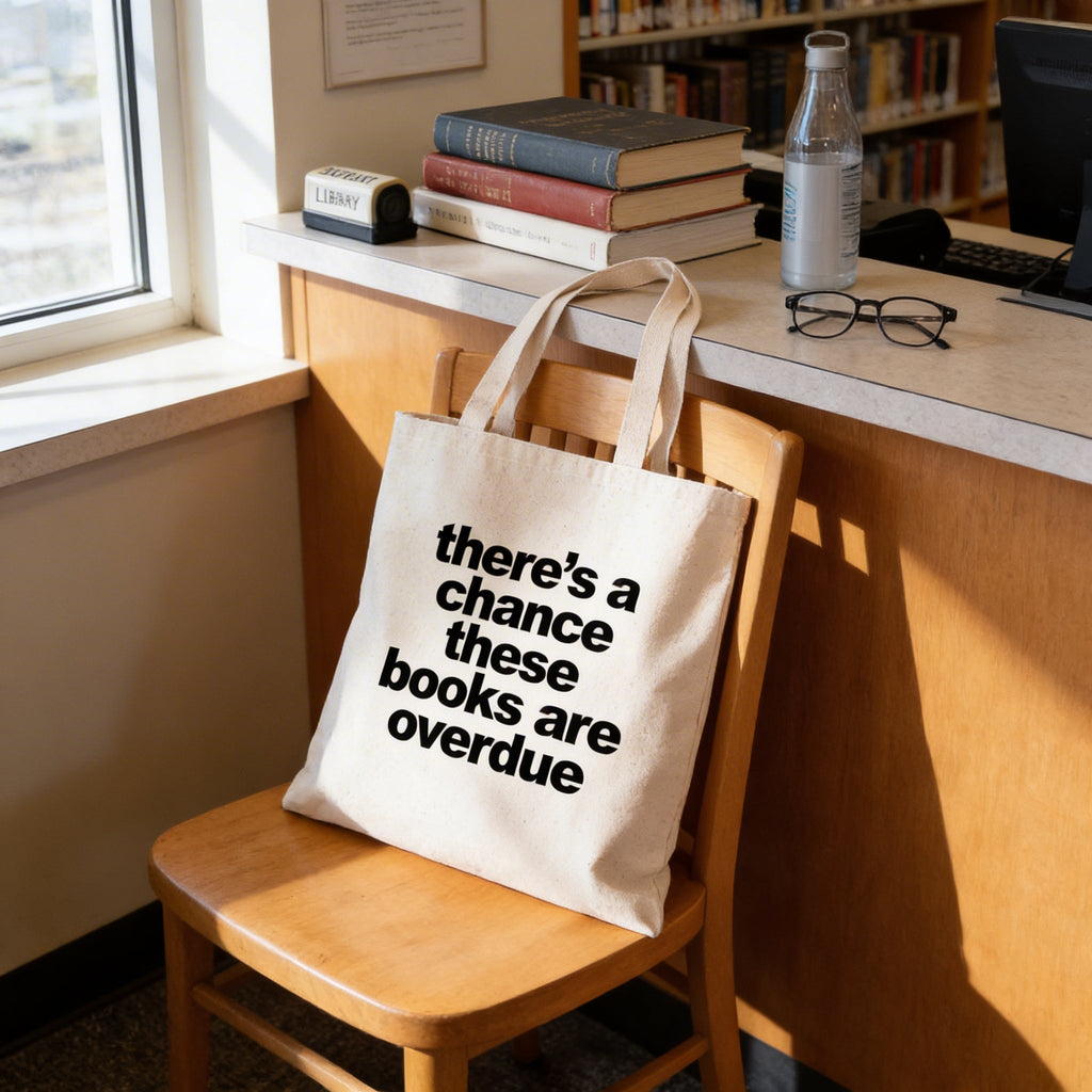 Canvas tote bag on wooden chair with printed quote: there's a chance these books are overdue