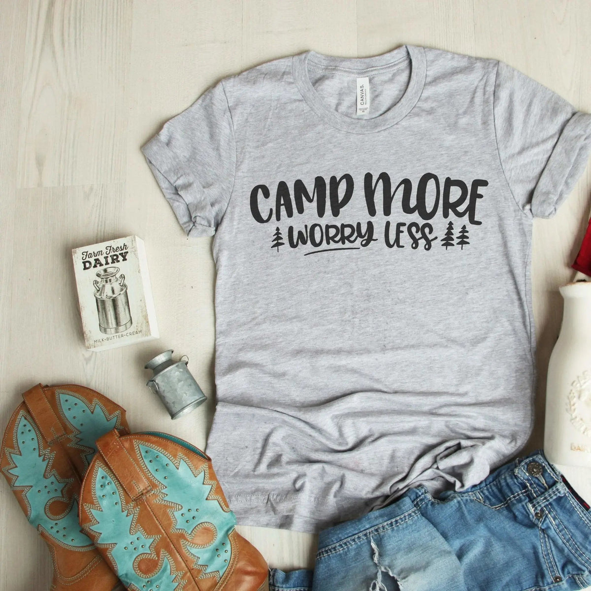Light gray T-shirt with 'CAMP MORE WORRY LESS' camping graphic and pine tree print